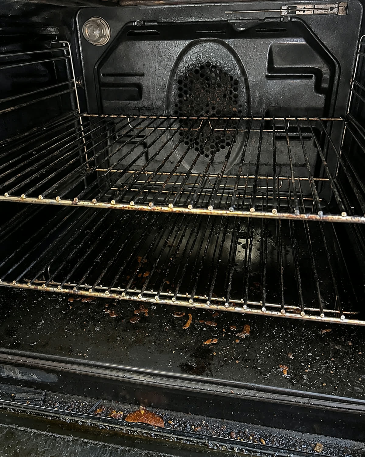 Oven interior before cleaning, with burnt-on residue