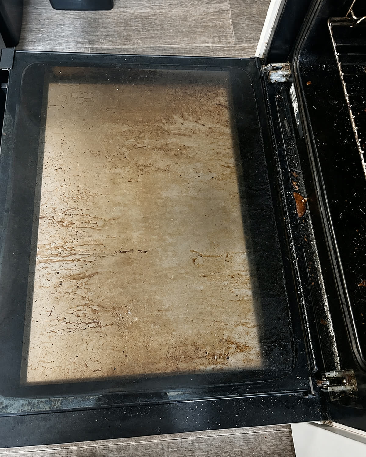 Greasy oven tray before cleaning