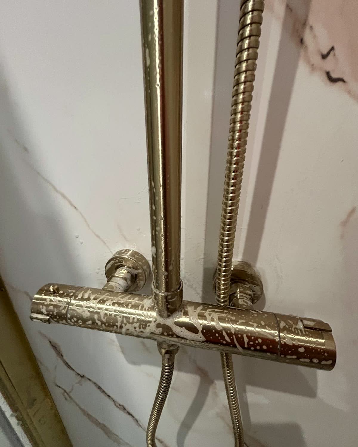 Limescaled shower fittings before cleaning